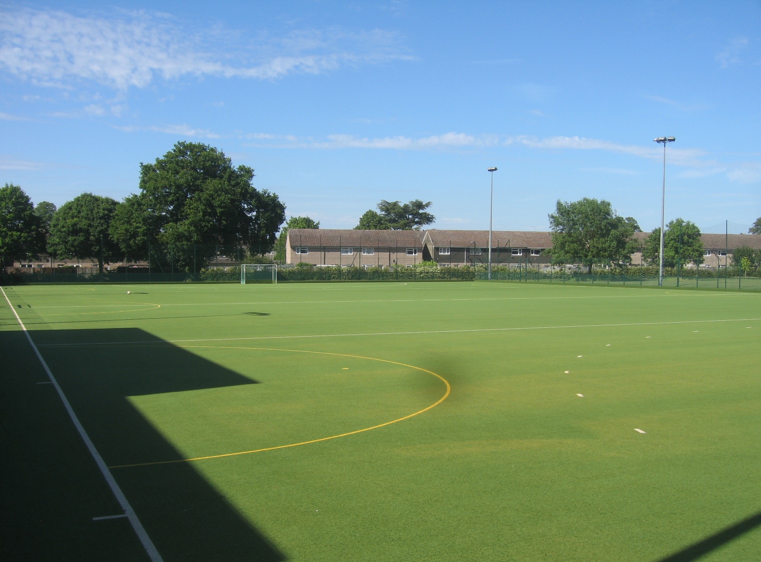 Full artificial-turf sports pitch with white field markings
