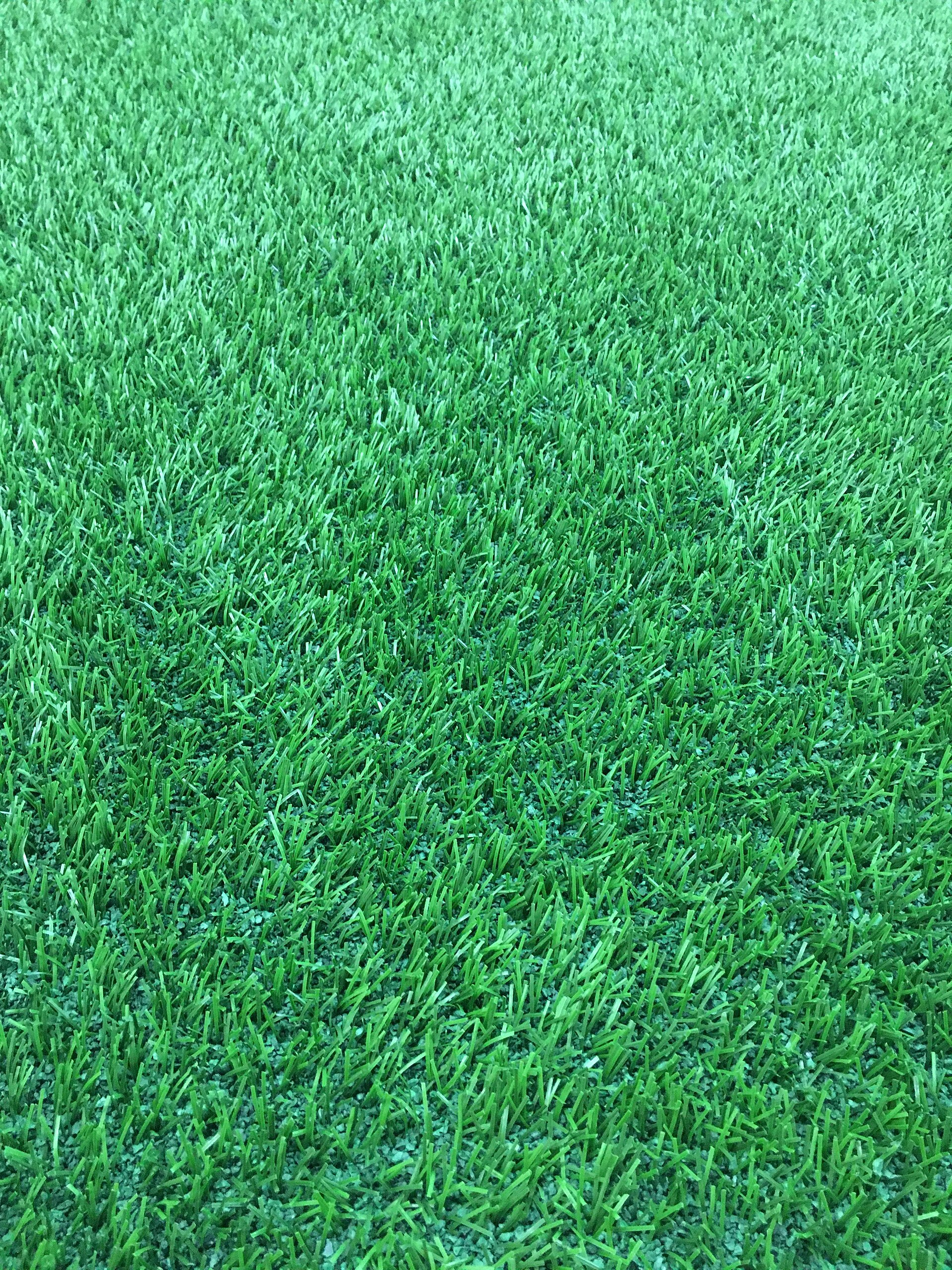 Close-up of green artificial-turf yarn and surface texture