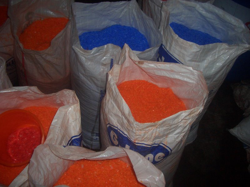 Filled sacks of plastic granulate stored together